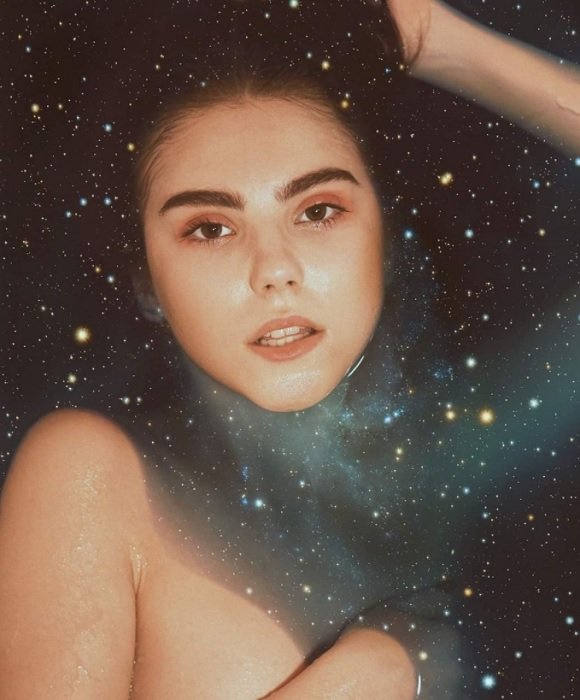 A composite image of a woman having a bath in space