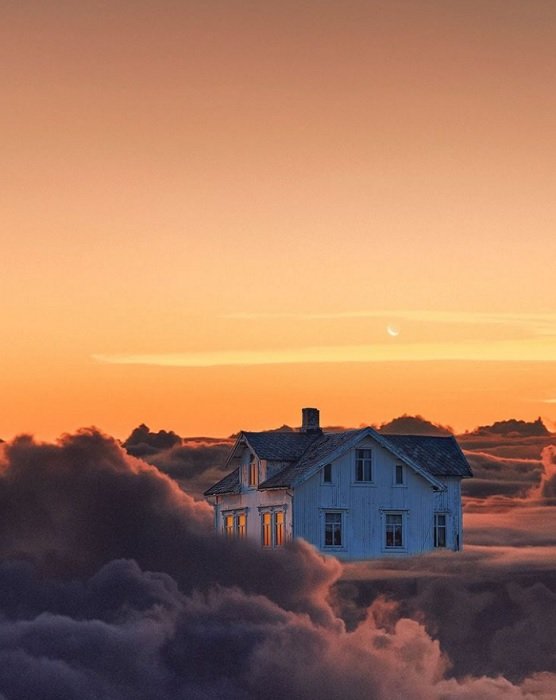 a composite image of a house on top of the clouds with a vibrant orange sky in the background