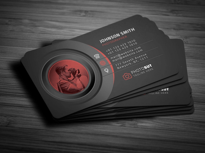 photography business card with photographer in the camera lens