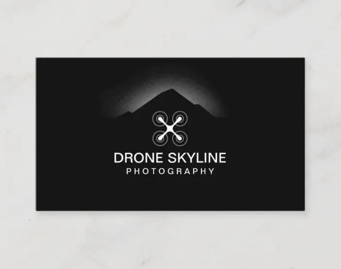 photography business card that shows a white vector of a drone against a black background