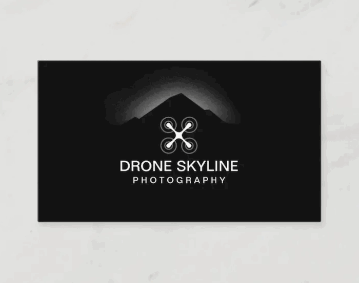 photography business card that shows a white vector of a drone against a black background