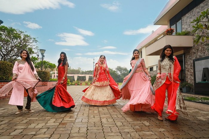 Five women in traditional Indian clothes