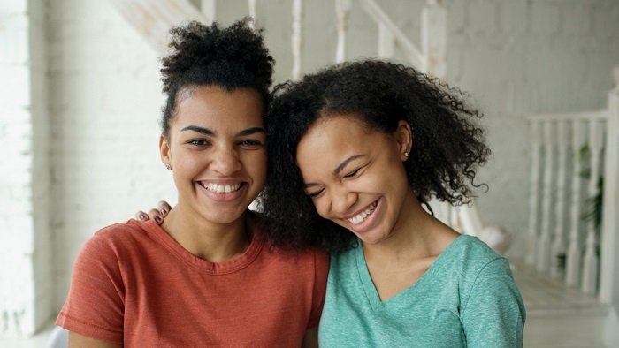 sister photoshoot ideas: Two Women Laughing Together
