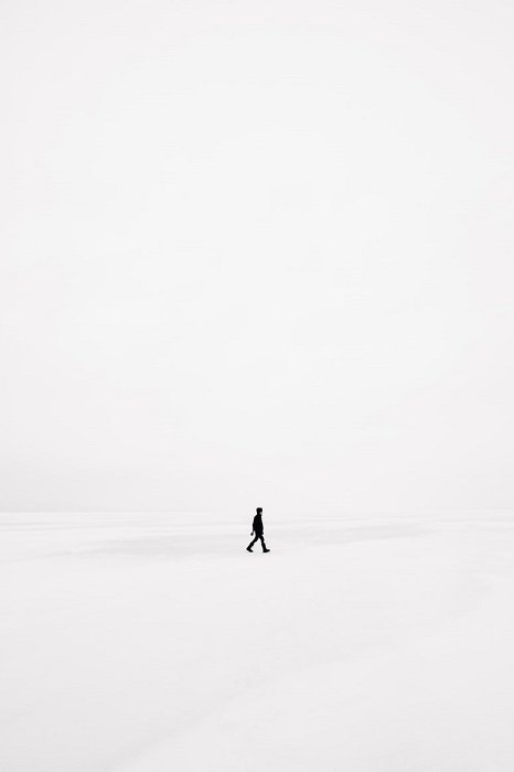 Surreal Photography example of a man walks on pure white landscape