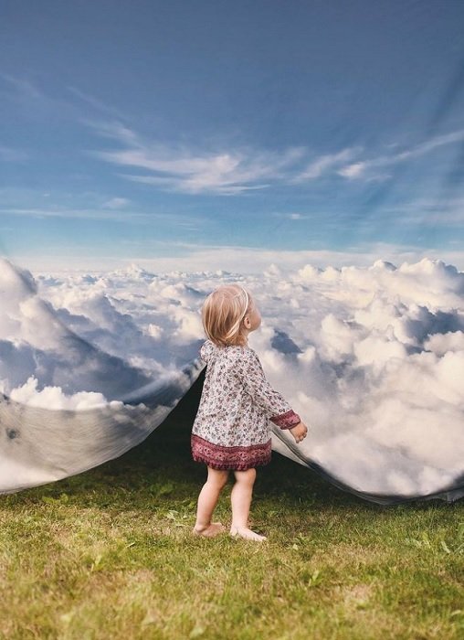 Surreal Photography example of a young girl lifting cloud curtain