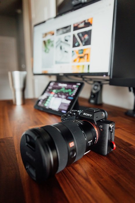 Sony A7R on a table in front of a computer screen