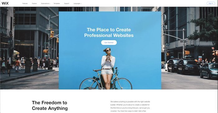 Screenshot of wix a website builder's homepage with woman and a bike