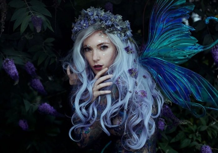 Portrait of woman dressed a fairy with lots of flowers