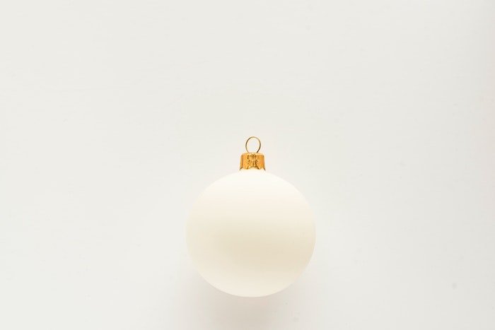 Soft light on a white Christmas ornament against a white background