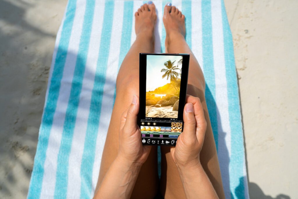 A person using a photo editing app on the beach