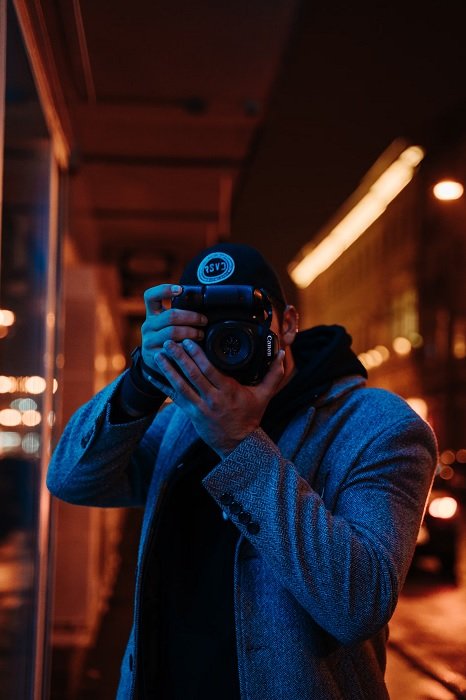 Man with camera in neon setting