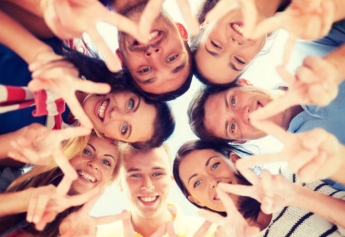 Group of people looking down at camera for a best friend photoshoot