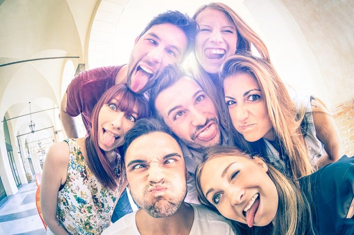 Group of friends pulling faces at the camera as an idea for a best friend photoshoot