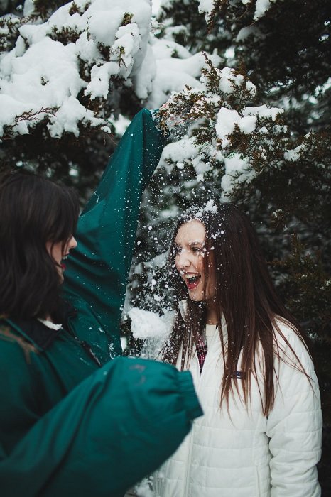 Two girls playing in the snow
