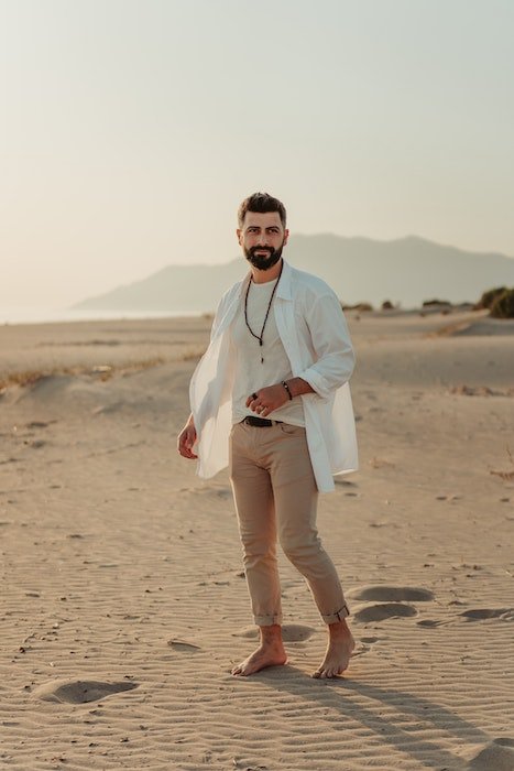 Man standing on a beach as an idea for male poses
