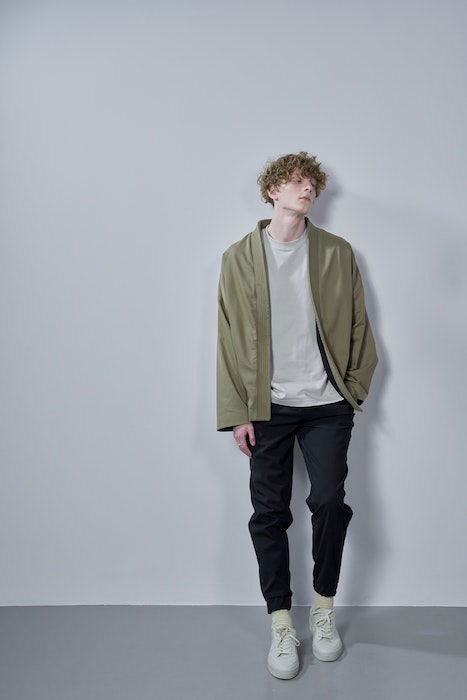 A male model leaning on the wall as an idea for male fashion poses