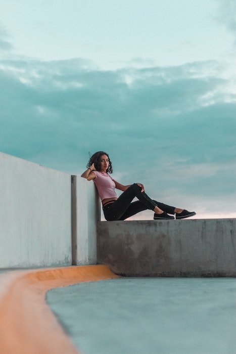 Woman reclining on a concrete slab as an idea for model poses