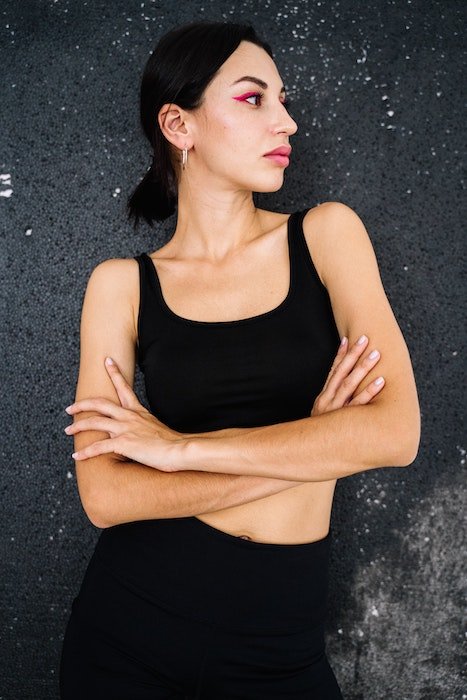 Woman in black posing with crossed arms