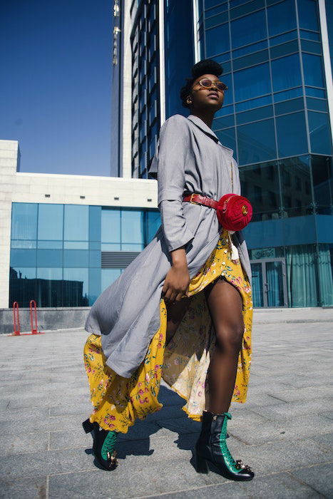 Full body shot of a woman walking with fashionable clothes and sunglasses on