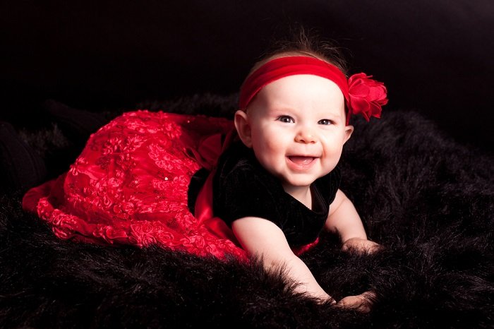 Newborn photo idea of a baby girl in black and red dress