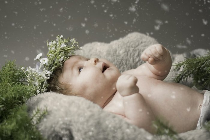 Christmas baby in snowing scene during a newborn photoshoot