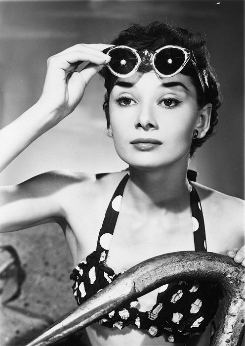 Audrey Hepburn lifting sunglasses