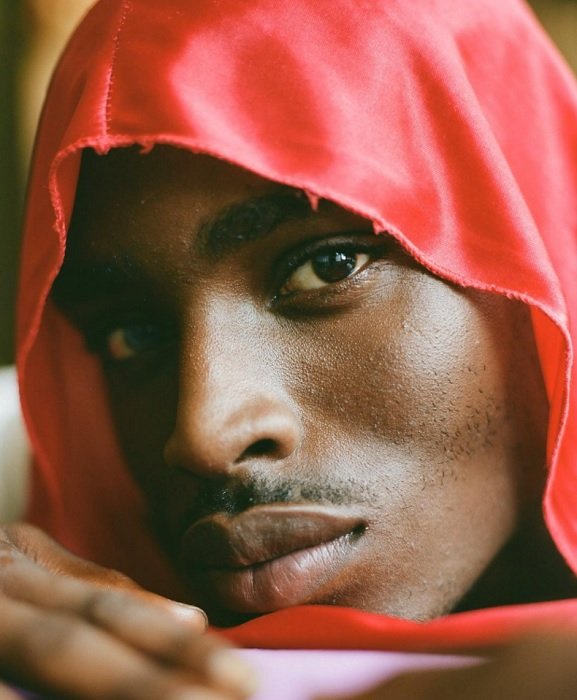 Close portrait of a man in a red hood