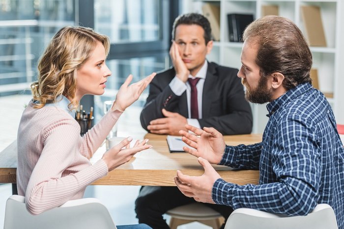Stock photo of three people in an office having an argument