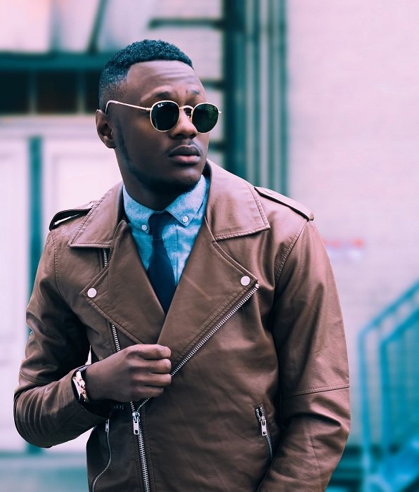 stock photo of a man in street wearing sunglasses and a brown leather jacket