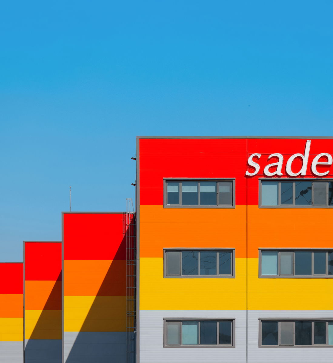 Buildings with analogous colors against a blue sky