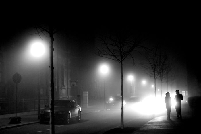 A city street shrouded in fog