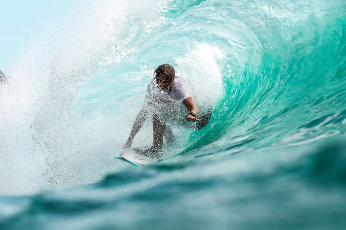 surf photography example of a rider riding the barrel of a wave facing the camera