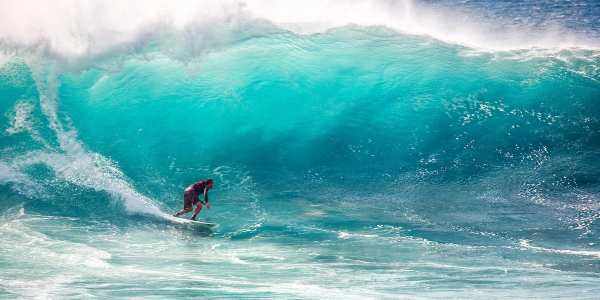A surfer at the bottom of a barrel wave as an example of surf photography