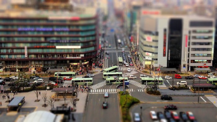 A tilt shift Photography view of a City Crossing
