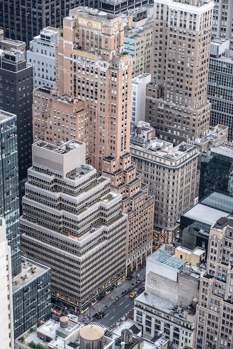A wide shot of a skyscraper with a city street below as an example of 25 Unique Examples of Tilt-Shift Photography