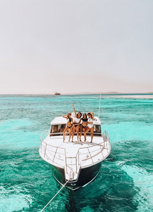 four young women on a boat