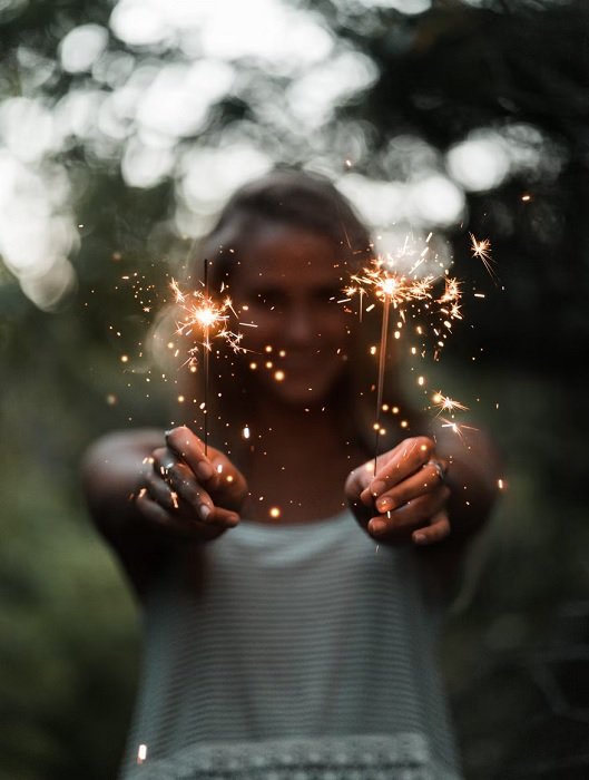 Girl holding a sparkler in each hand
