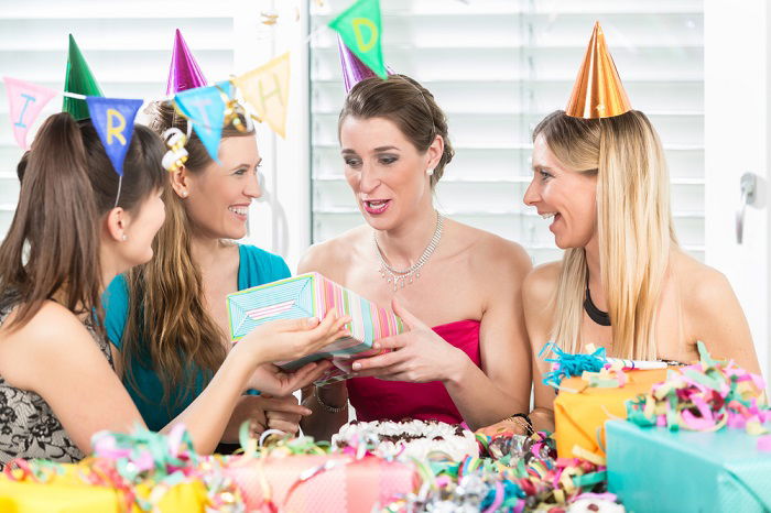 A birthday girl receiving gifts from friends