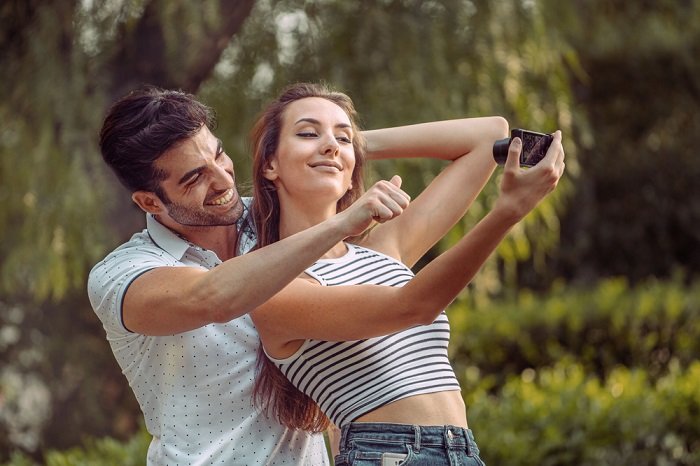 Couple taking a selfie together with a camera