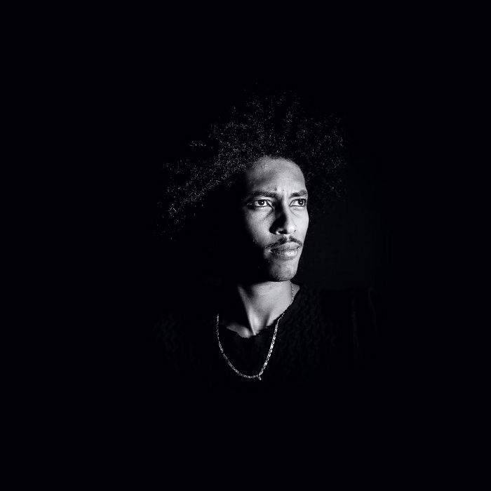 Black and white portrait of a mans face against a black background as an idea for showing emphasis in photography