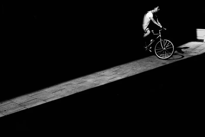 Black and white photo with cyclist