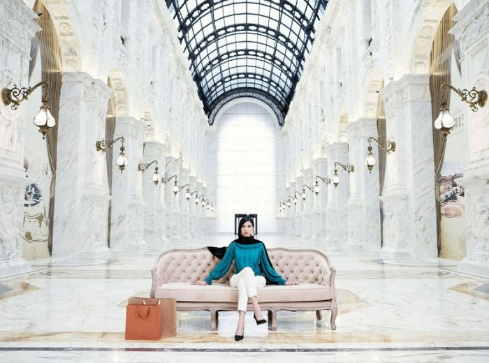 Wide portrait of woman in grand hall