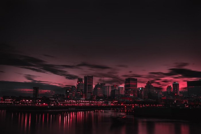 Photo of a cityscape at night with red lights