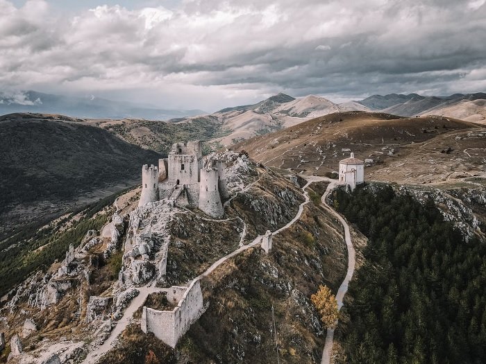 Bird's eye view of a castle on a hill shot with a drone