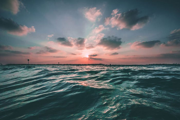 Sunset over the ocean, showing the beauty of ocean photography