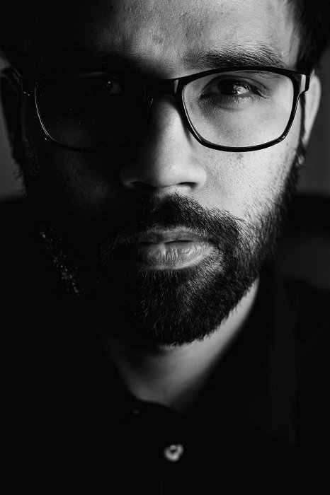 Close portrait of man with glasses in black and white