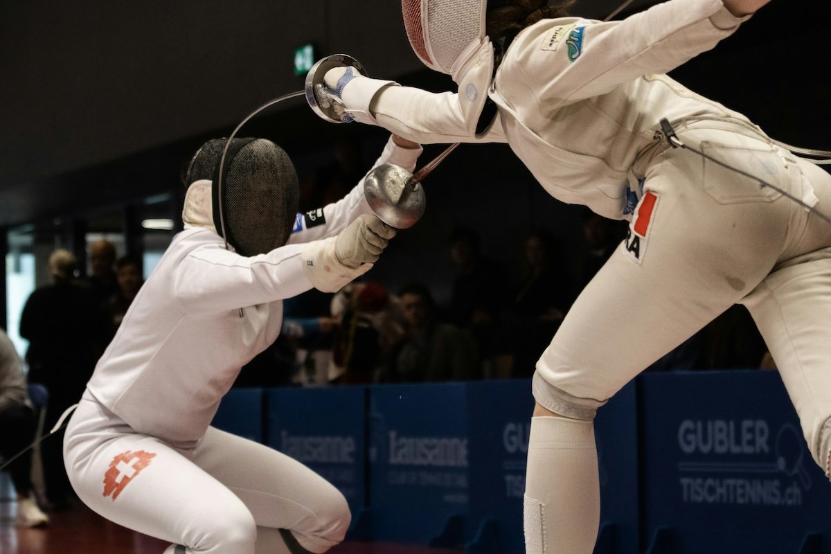 Two fencers dueling to show sports photography settings