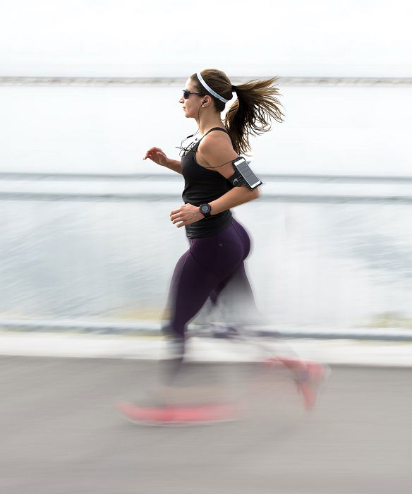 Woman running with legs blurred