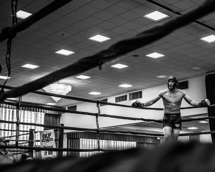 A boxer standing in the corner of the ring
