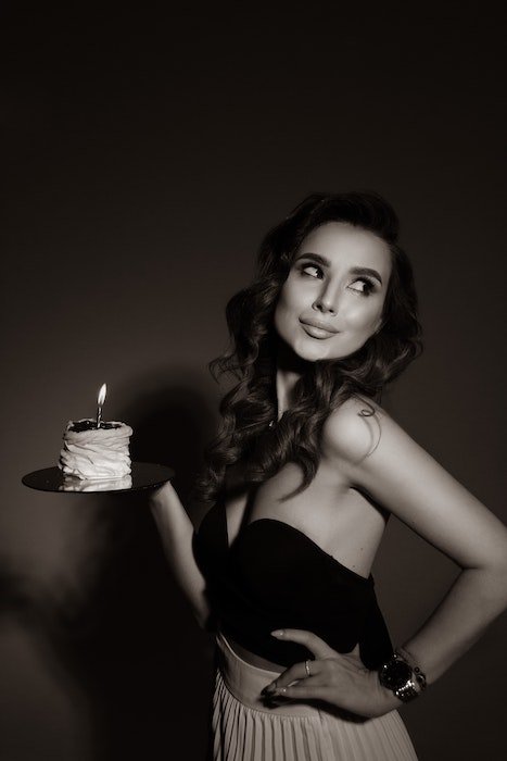 girl posing with birthday cake for a birthday photoshoot